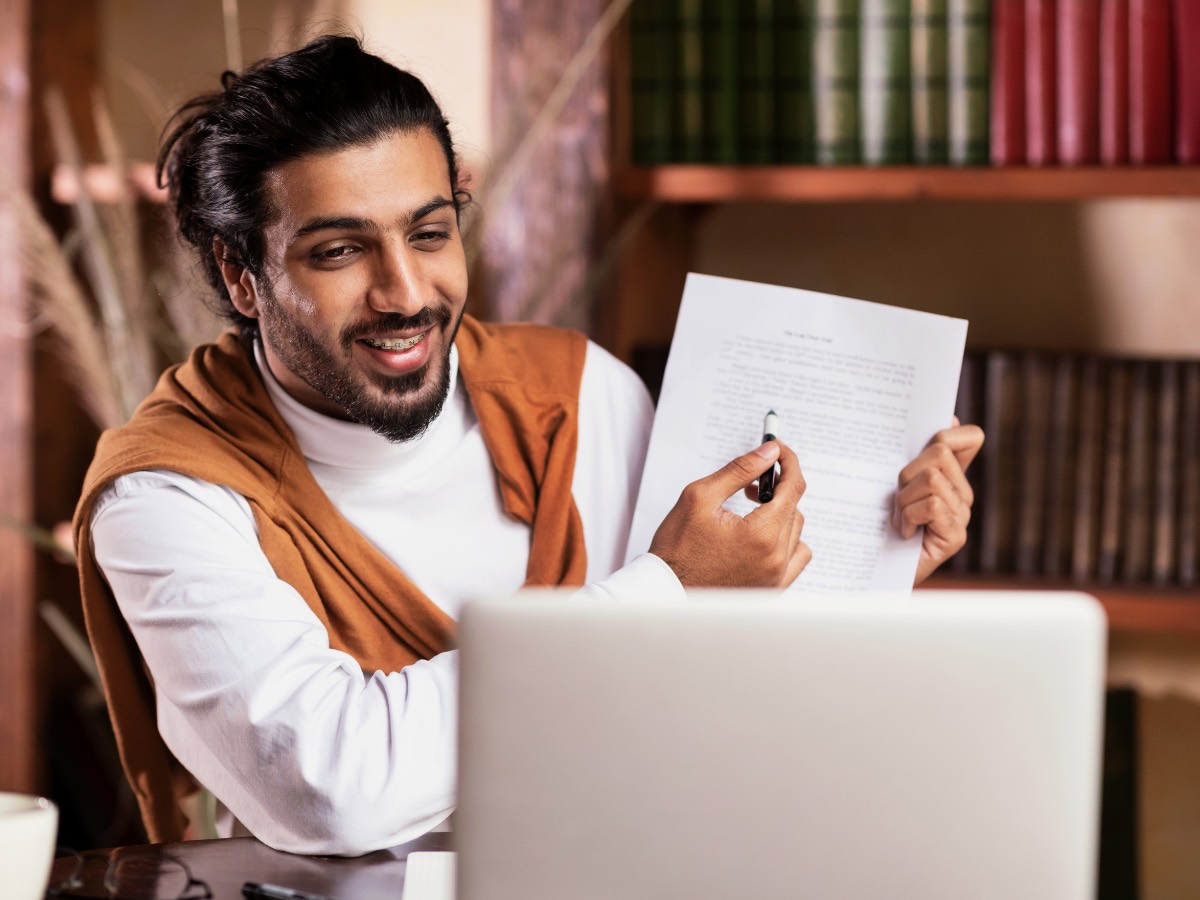 Tutor talking through a marked practice paper on a video call